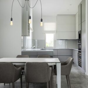 Lampe suspension araignée dans salle à manger avec chaises grises